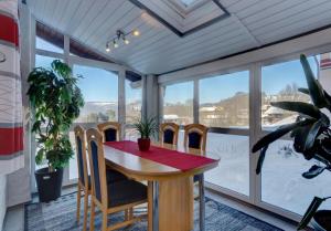 a dining room with a table and chairs in front of a window at Ferienwohnung Christina in Mauth +38 photos