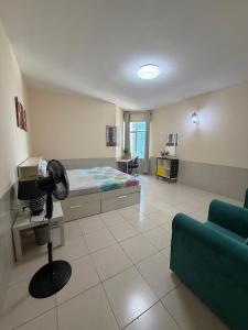 a living room with a bed and a couch at Spacious and Calm in Ajman 