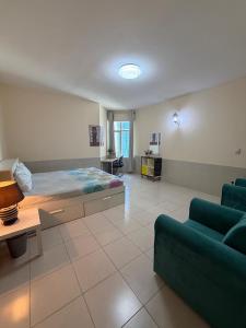 a bedroom with a large bed and a couch at Spacious and Calm in Ajman 