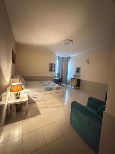a bedroom with a bed and a couch and a table at Spacious and Calm in Ajman 