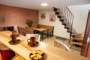 a restaurant with a table and chairs and a staircase at Sklípek Nechory in Prušánky
