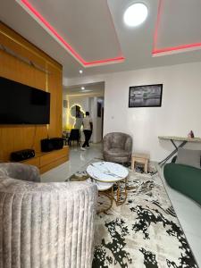 a living room with a couch and a table at Waterfront 3BR Lekki Lagoon View in Maiyegun