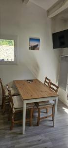 a wooden table and chairs in a room at cosy studio in Saint-Maximin-la-Sainte-Baume