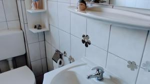 a small bathroom with a sink and a toilet at Geesthaus Geestland in Geestland