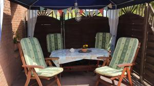 a table and chairs in a gazebo at Geesthaus Geestland in Geestland