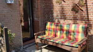 a chair sitting on a patio next to a brick wall at Geesthaus Geestland in Geestland