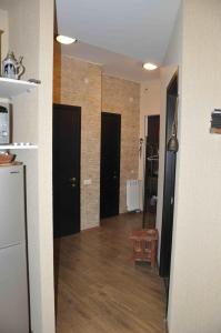 a room with a hallway with black doors and wooden floors at Ski Sun & Fun - next to iconic Marco Polo in Gudauri +9 photos