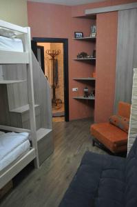 a room with a bunk bed and a chair and a mirror at Ski Sun & Fun - next to iconic Marco Polo in Gudauri