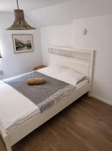 a bedroom with a white bed with a wooden floor at villa vidalis in Veliko Golovode