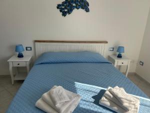a bedroom with a bed with two towels on it at Mare fuori in Villasimius +11 photos