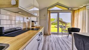 a kitchen with a sink and a counter top at Domki Izerskie in Krobica