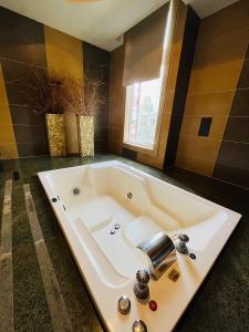 a large bath tub in a bathroom with a sink at Walker Motel 2 in Taipei