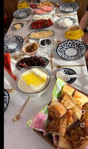 a long table with plates of food on it at Stariy Marokand in Samarkand +18 photos
