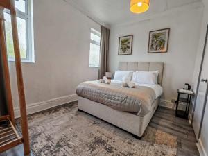 a bedroom with a large bed and a window at The Forest- Greenwood in Cambridge