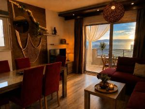 a living room with a couch and a table with a view at Johanan in Makarska