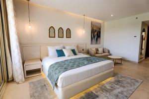 a bedroom with a large bed and a couch at Sunrise Mamlouk Palace Resort in Hurghada