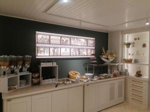 a kitchen with a counter with food on it at Gasthof Uthmann in Bad Iburg