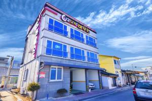 a building with a sign on the side of it at Sokcho otwohouse pension in Sokcho
