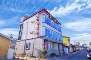 a building with a sign on the side of it at Sokcho otwohouse pension in Sokcho