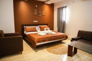 a bedroom with a bed with a towel on it at Résidences AMAN in Morofé +38 photos