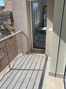 a balcony with a glass door on a building at Domus Palatium in Palazzolo Acreide