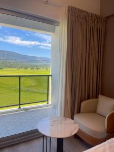 a room with a window with a couch and a table at Go Chishang B&B in Chishang