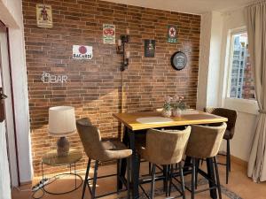 a room with a table and chairs and a brick wall at HondaMar in Playa Honda