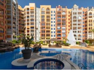 a large swimming pool in front of some buildings at HondaMar in Playa Honda