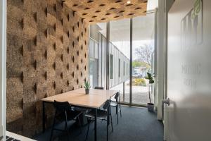 a dining room with a wooden table and chairs at Codomo Living Carcavelos Lombos in Carcavelos