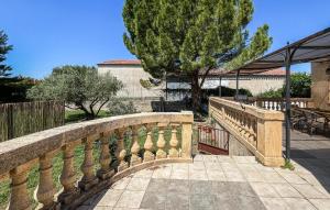 a stone bridge over a walkway in a yard at Maison Proche Uzès in Vers Pont du Gard