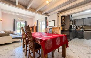 a kitchen and dining room with a table and chairs at Maison Proche Uzès in Vers Pont du Gard