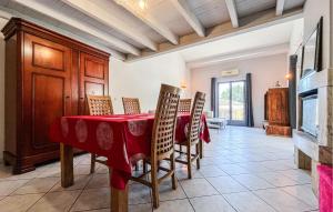 a dining room with a red table and chairs at Maison Proche Uzès in Vers Pont du Gard +18 photos