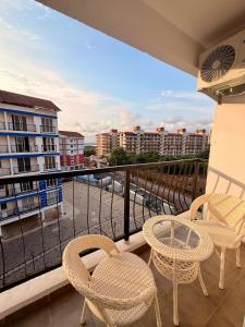 a balcony with two chairs and a table on a balcony at Bay Breeze 2BR Apt Amoret Homes in Chicalim