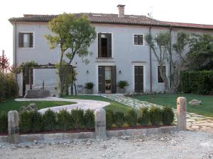 a large white house with a garden in front of it at Da Nicola in Montegrotto Terme
