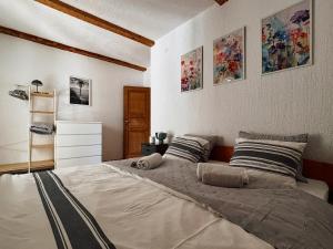a bedroom with a large bed with paintings on the wall at Villa Vika Apartments in Njivice +88 photos