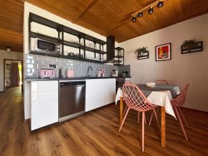 a kitchen with a table and chairs in a room at Villa Vika Apartments in Njivice