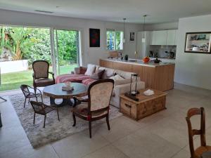 a living room with a couch and a table and chairs at La Petite Bergerie in Fréjus