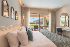 a bedroom with a large bed and a balcony at Sunrise Mamlouk Palace Resort in Hurghada