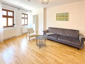 a living room with a couch and a table at Altstadtidyll in Lübbenau