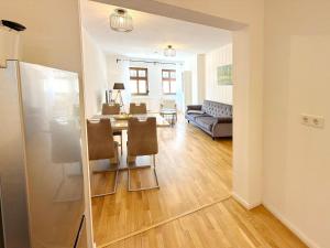 a dining room and living room with a table and chairs at Altstadtidyll in Lübbenau