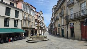 a city street with a fountain in the middle at Loft Casco Viejo 4 in Ourense