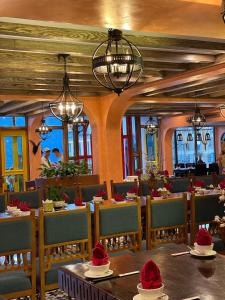 a restaurant with tables and chairs with hats on them at SAPA DEBOUTIQUE Hotel in Sapa
