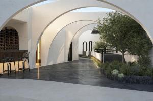 an archway in a building with a table and chairs at Mamay Hotel in Fira