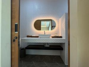 a bathroom with a sink and a mirror at Plerntaan HoReCa in Ban Khlong Kum +59 photos