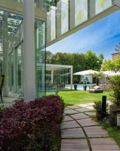an exterior view of a glass building with a garden at Villa Maria Cristina in Caserta