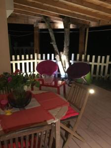 a dining room with a table and chairs and a fence at Les Terrasses Levantines in Île du Levant