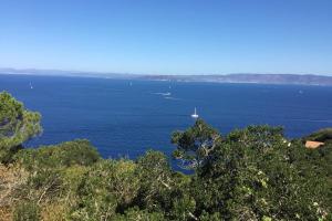 a large body of water with a boat in it at Les Terrasses Levantines in Île du Levant +69 photos