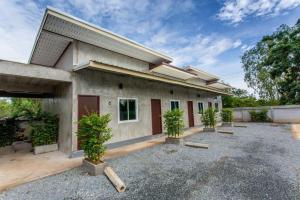 a building with trees in front of it at Sun Resort in Sa Kaeo