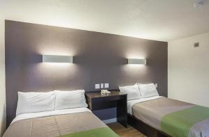 a hotel room with two beds and two lamps at Studio 6 Buttonwillow, CA in Bowerbank