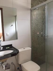 a bathroom with a toilet and a sink and a shower at Pousada Lagoa Seca in Juazeiro do Norte +40 photos